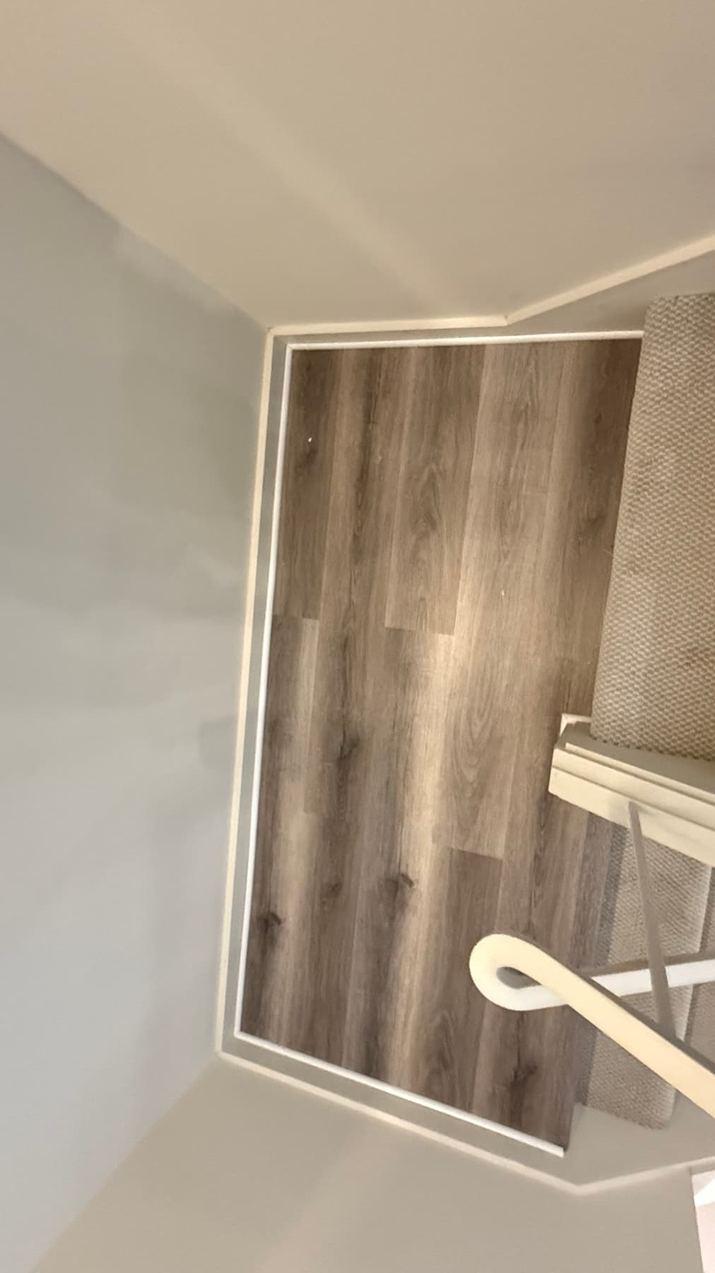 Completed Rhino LVP floor near a stair transition in a real home